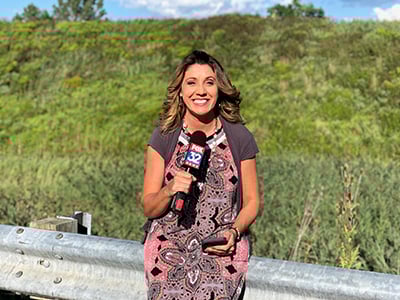 Michele Fiore Photo of Michele Fiore sitting on road rail while holding a Fox TV Microphone