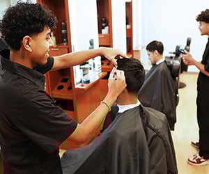 Barber Certificate Program Student cutting hair of another student